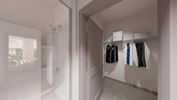 a walk in closet in a home with a glass door